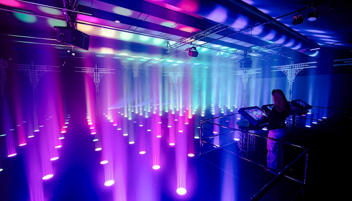 Interactive light installation at Amaze Amsterdam with visitor using control panel.