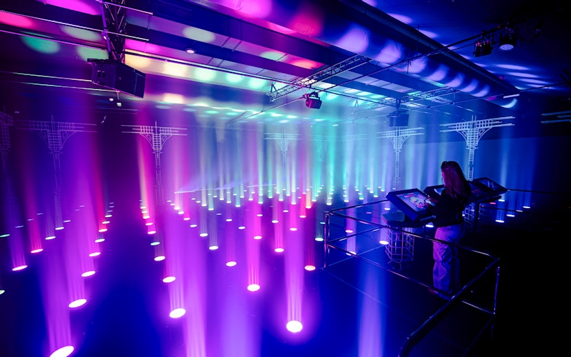 Interactive light installation at Amaze Amsterdam with visitor using control panel.