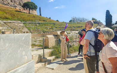 Guided tour group at the Acropolis in Athens with a guide explaining the site.