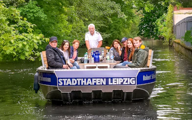 Guests on a motorboat tour through Auwald forest in Leipzig.