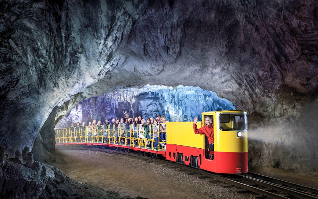 Tourists on a train ride inside Postojna Cave, Slovenia.
