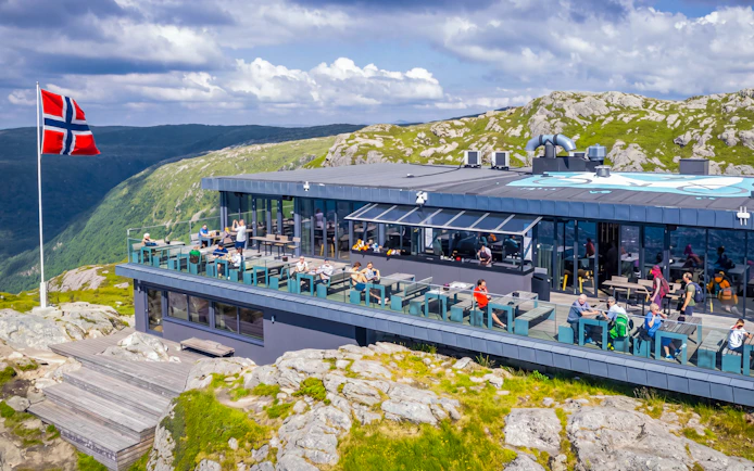 Skyskraperen Restaurant terrace with diners, Ulriken mountain view, Norway.