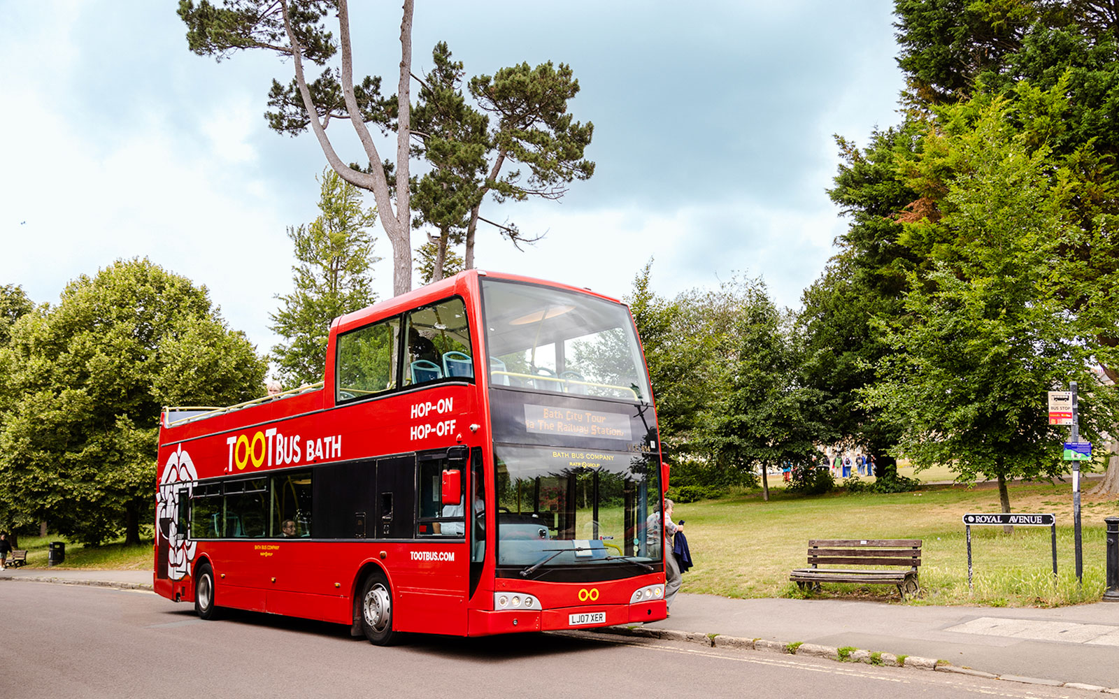 Red Toot Bus for hop-on hop-off city tour in Bath, parked near Royal Avenue.