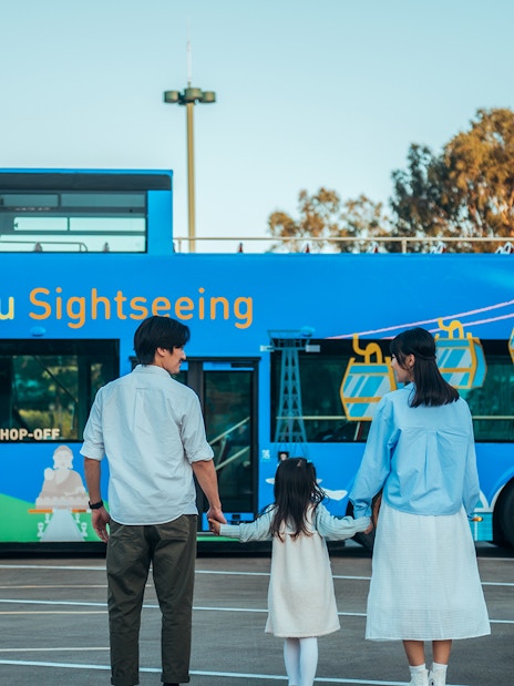 Family standing in front of BigBus Lantau Island sightseeing bus.