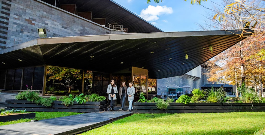 Tourists outside National Gallery of Victoria, enjoying garden view before 3-course lunch.