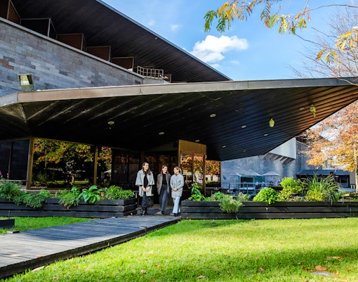 Tourists outside National Gallery of Victoria, enjoying garden view before 3-course lunch.