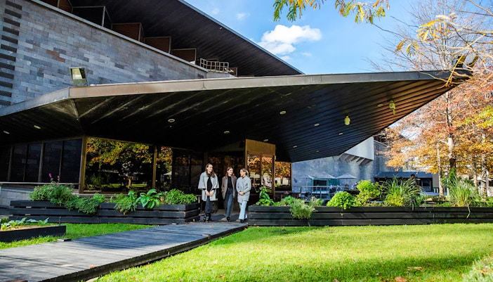Tourists outside National Gallery of Victoria, enjoying garden view before 3-course lunch.