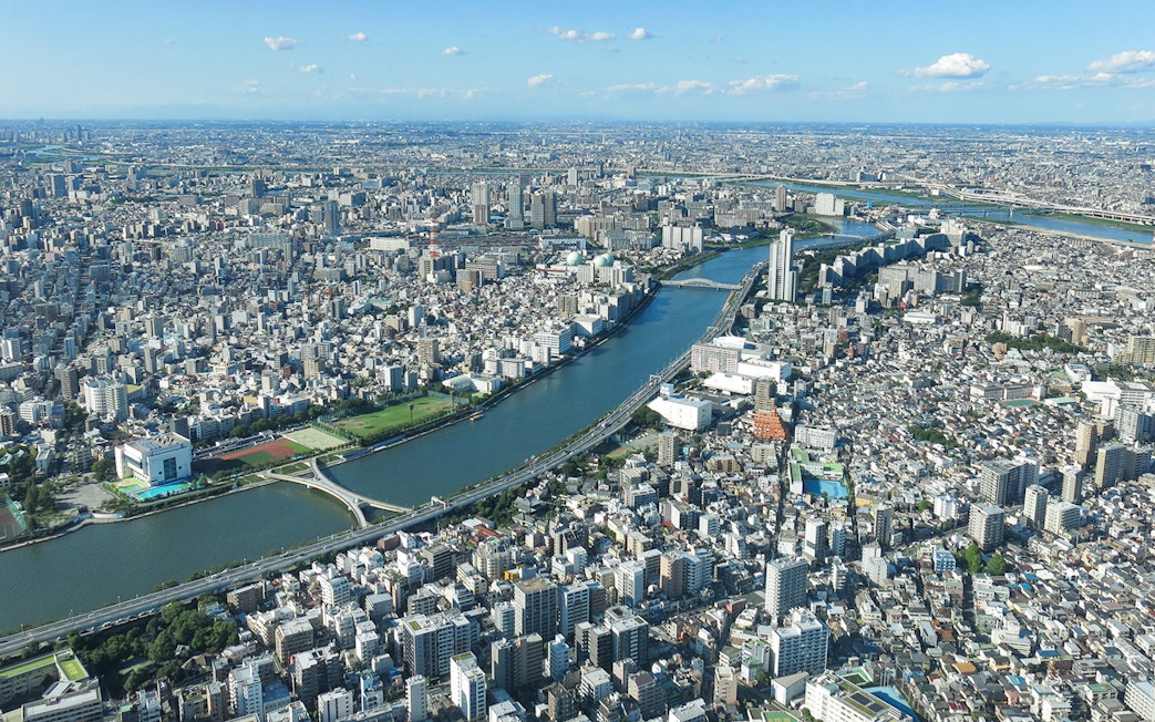 Aerial view of Tokyo cityscape from Tembo Deck and Tembo Galleria, showcasing river and urban landscape.