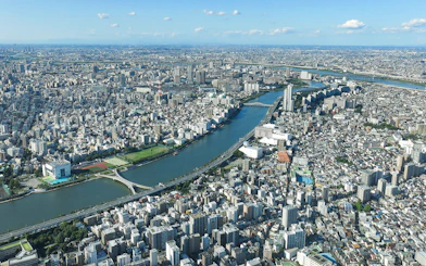 Aerial view of Tokyo cityscape from Tembo Deck and Tembo Galleria, showcasing river and urban landscape.