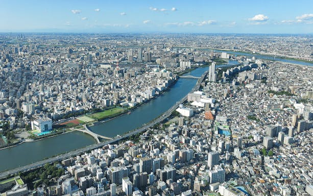 Aerial view of Tokyo cityscape from Tembo Deck and Tembo Galleria, showcasing river and urban landscape.