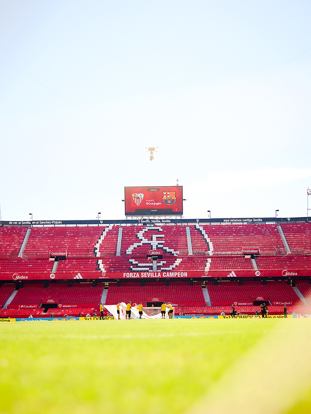 Sevilla FC's Ramón Sánchez Pizjuán Stadium with staff preparing the field.
