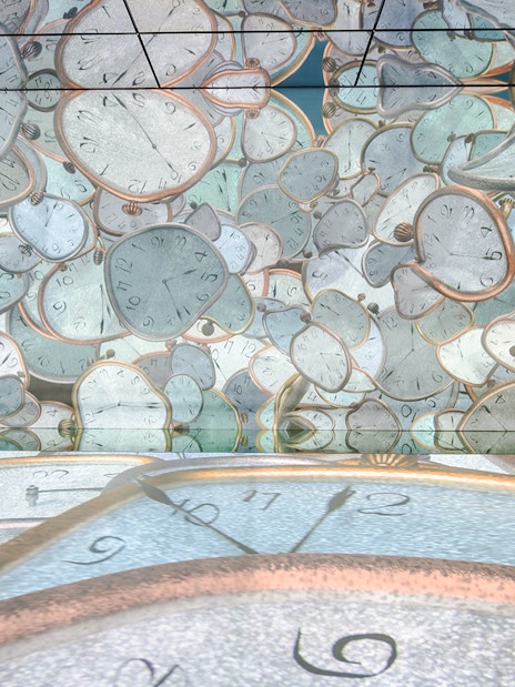 Visitors exploring melting clock projections at Frameless London immersive art exhibit.