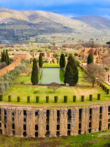 Ancient Roman ruins and gardens at Hadrian's Villa, Tivoli, Rome, with surrounding landscape.