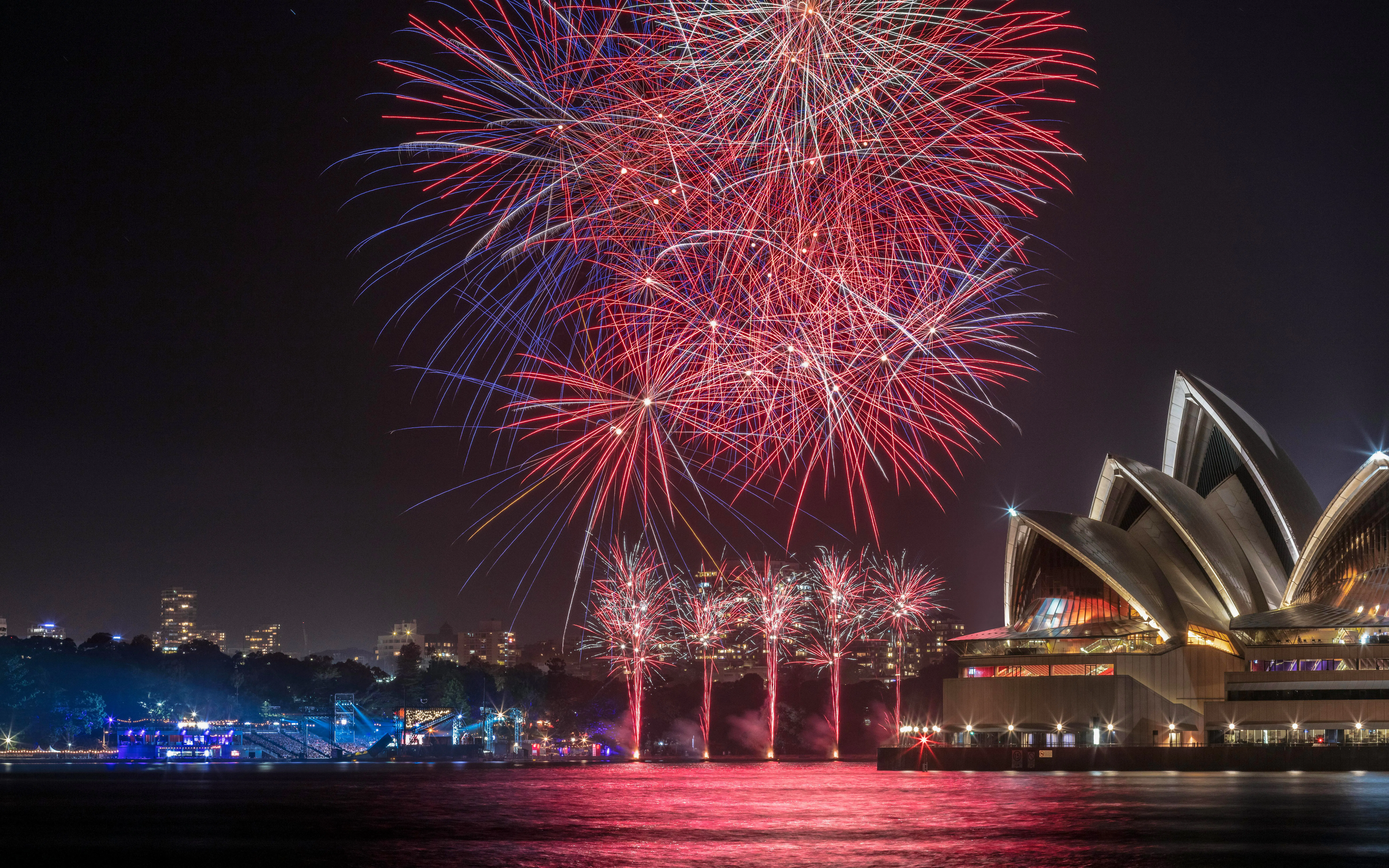 Fireworks display over Sydney Opera House during New Year's Eve celebration.