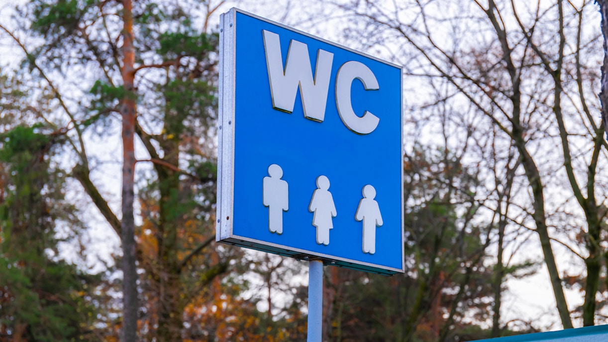 Restroom sign near Westminster Abbey with male and female symbols.