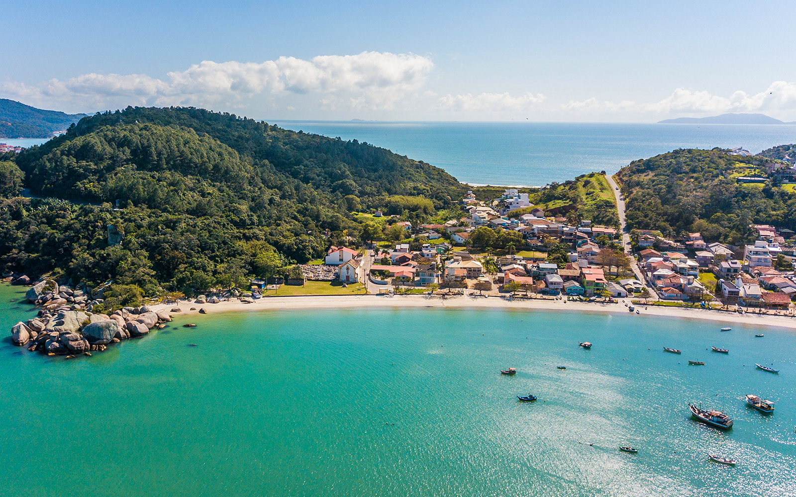 Aerial view of Armação da Piedade beach with boats and coastal village, Brazil.