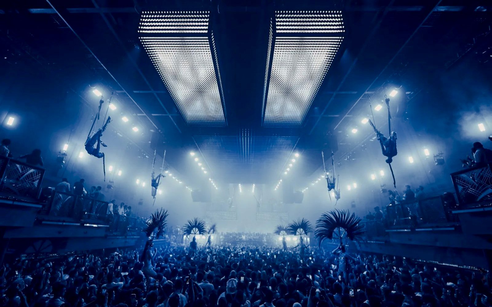 Aerial performers at UNVRS David Guetta Galactic Circus in Ibiza nightclub.