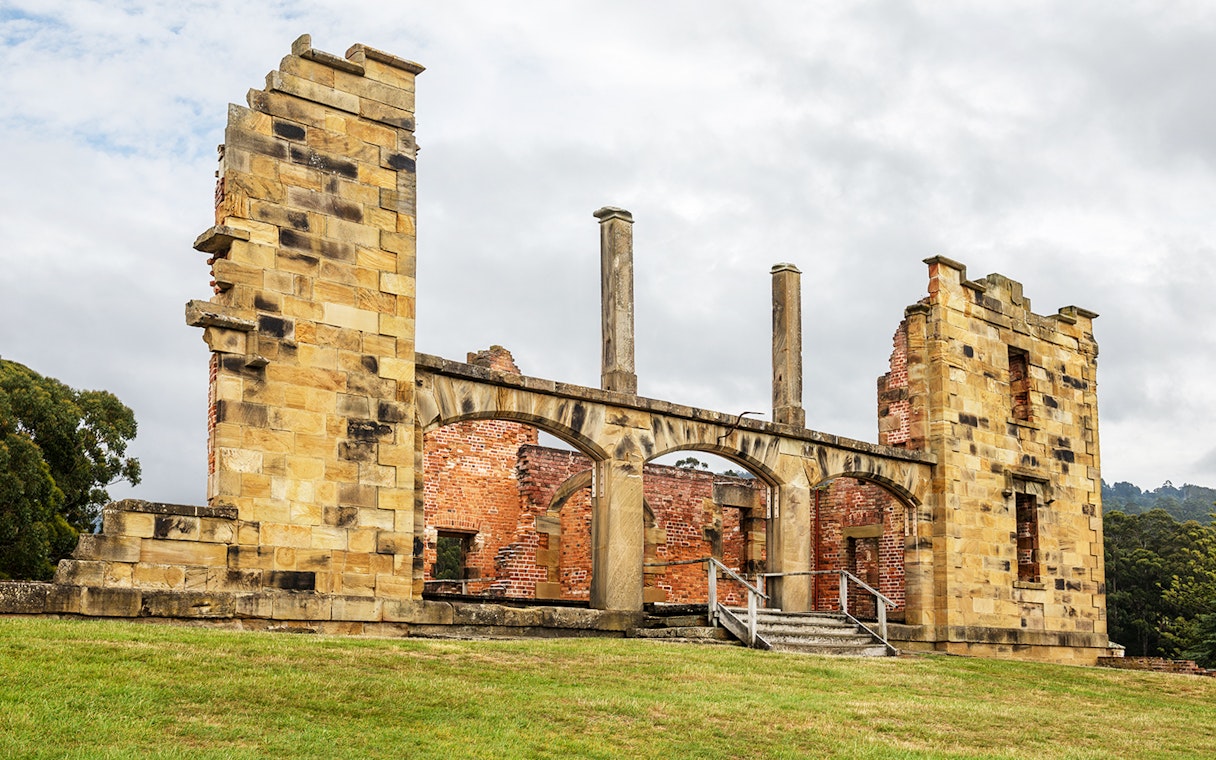 Port Arthur historic ruins with stone arches and brick walls on a guided tour in Tasmania.