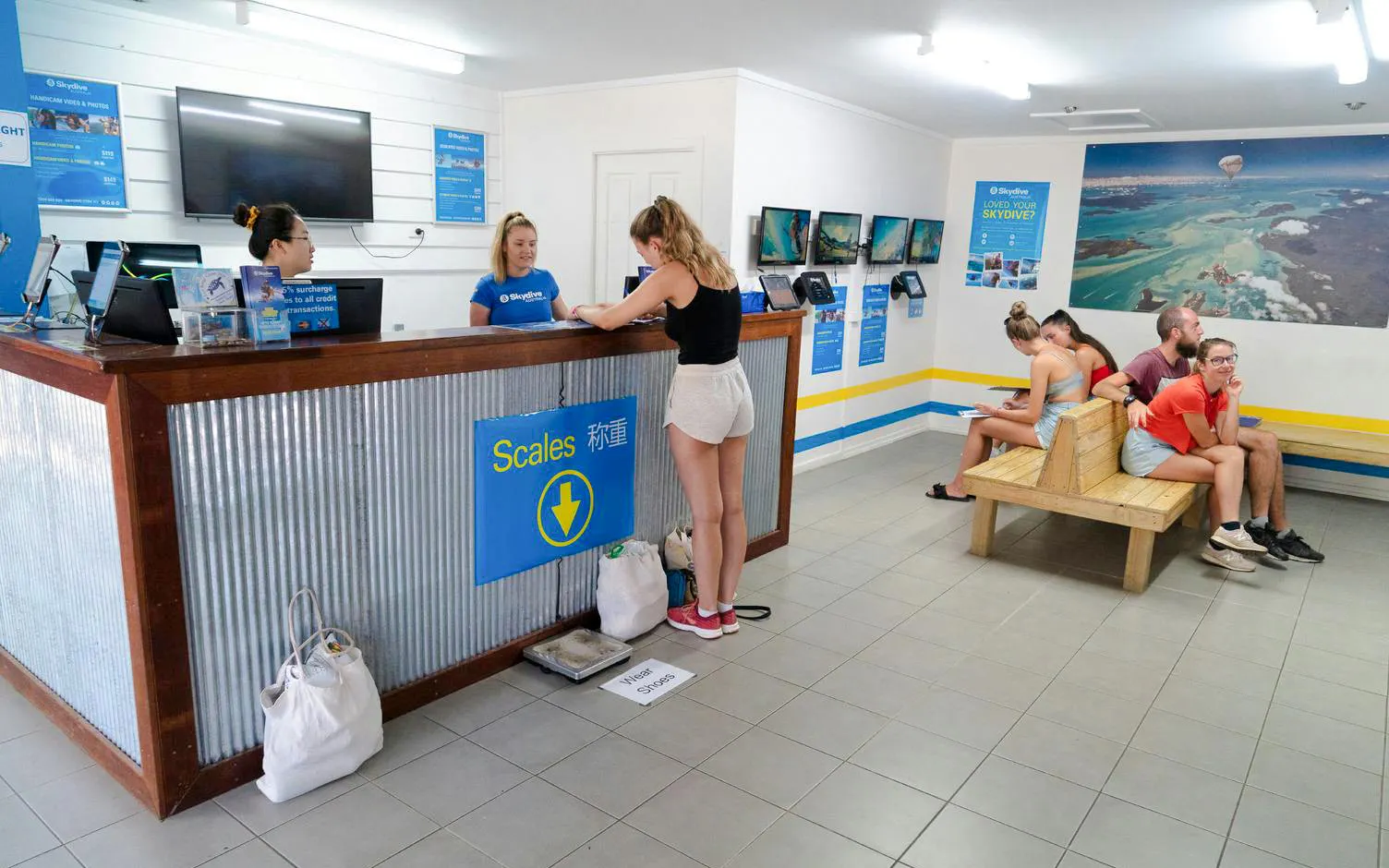 Customer checking in at Tandem Skydive Mission Beach reception area.