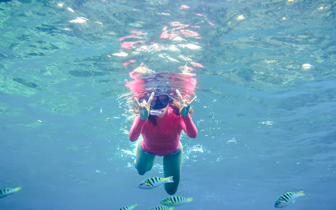 Girl snorkeling with fish in Saint-Jean-Cap-Ferrat, Nice, France.