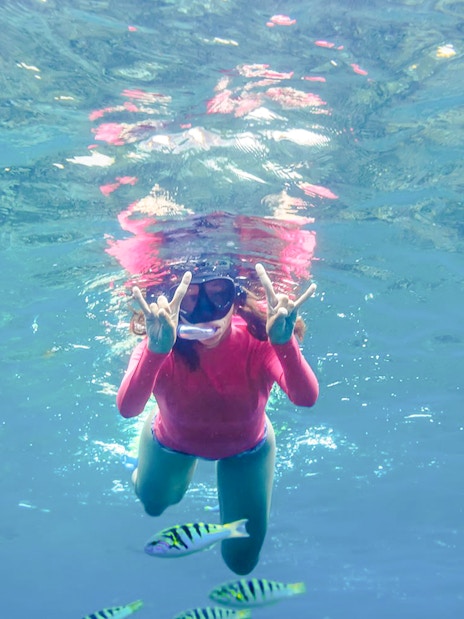 Girl snorkeling with fish in Saint-Jean-Cap-Ferrat, Nice, France.
