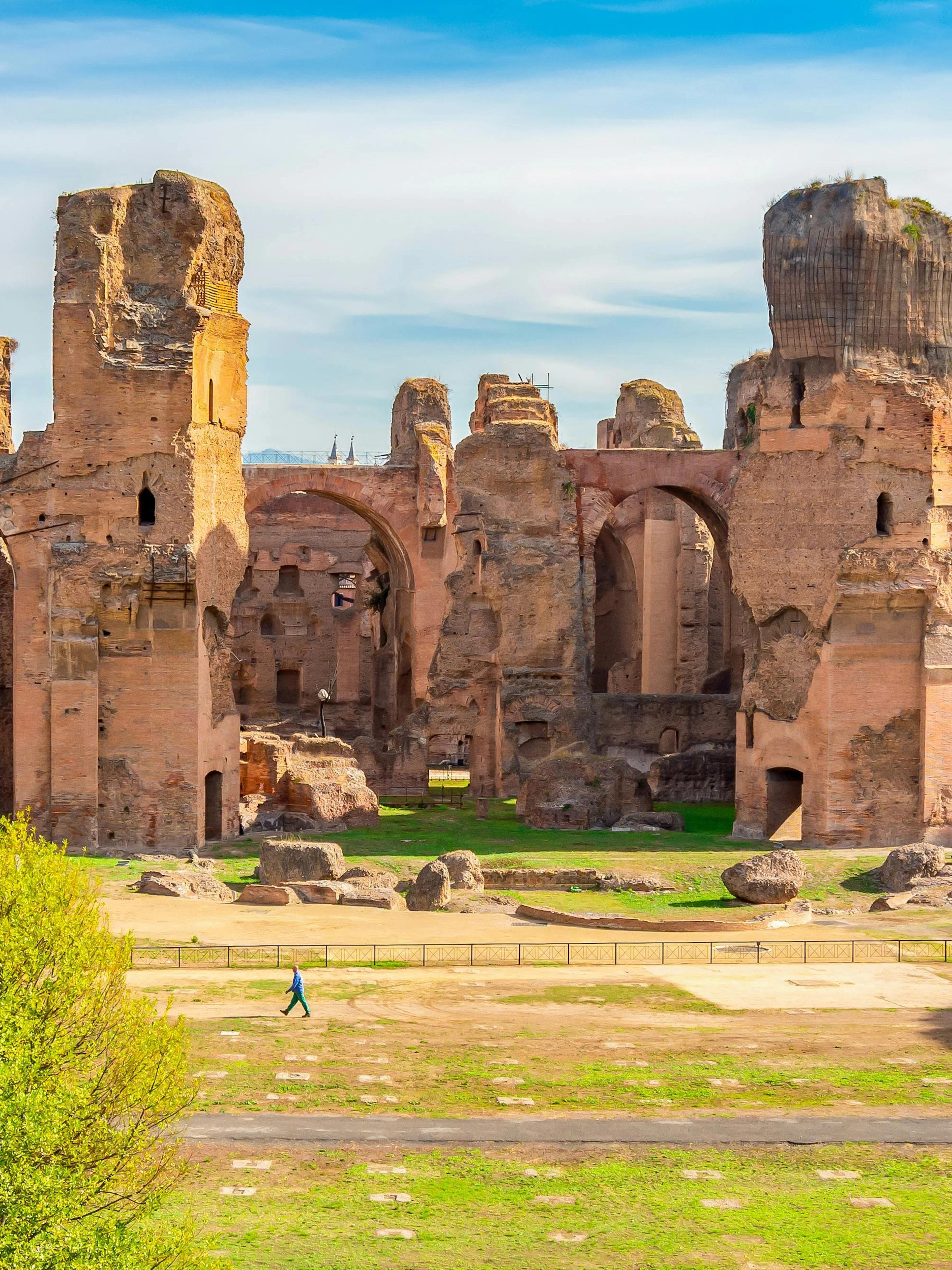 Baths of Caracalla ruins with arches and greenery in Rome, Italy.