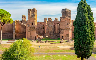 Baths of Caracalla ruins with arches and greenery in Rome, Italy.