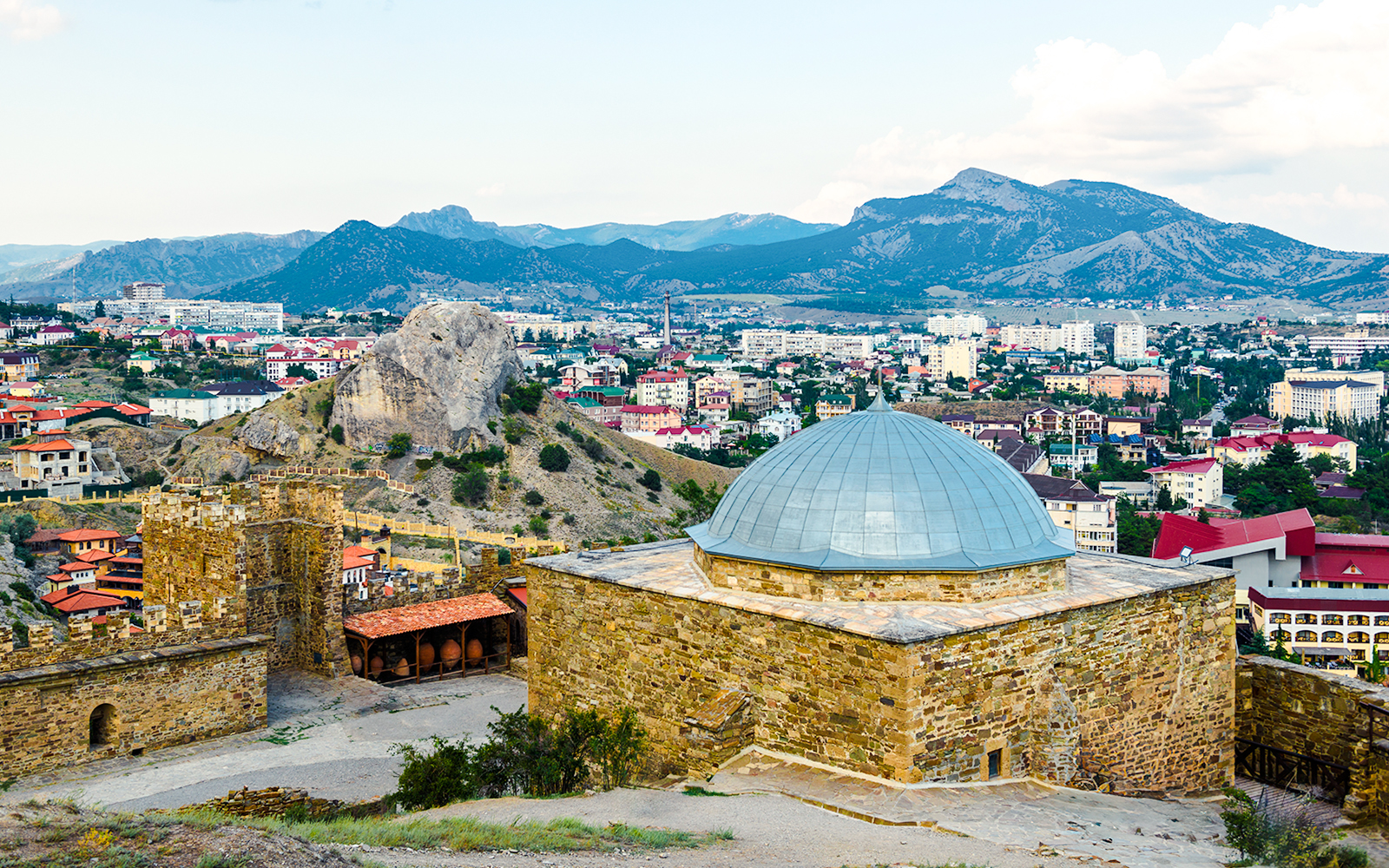 Genoese fortress mosque with cityscape and mountains in Istanbul.