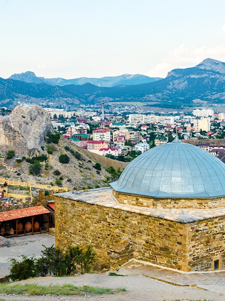 Genoese fortress mosque with cityscape and mountains in Istanbul.