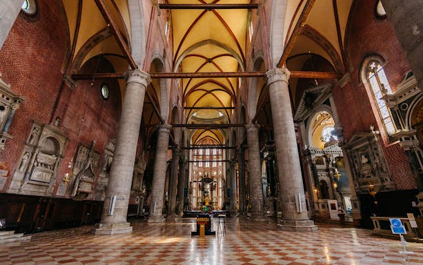 Interior of a historic church with vaulted ceilings and ornate columns, part of the Chorus Circuit Churches Pass.