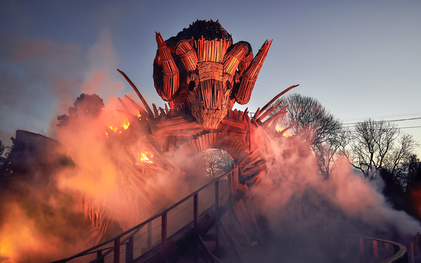 Wicker Man ride structure with flames and smoke at Alton Towers.