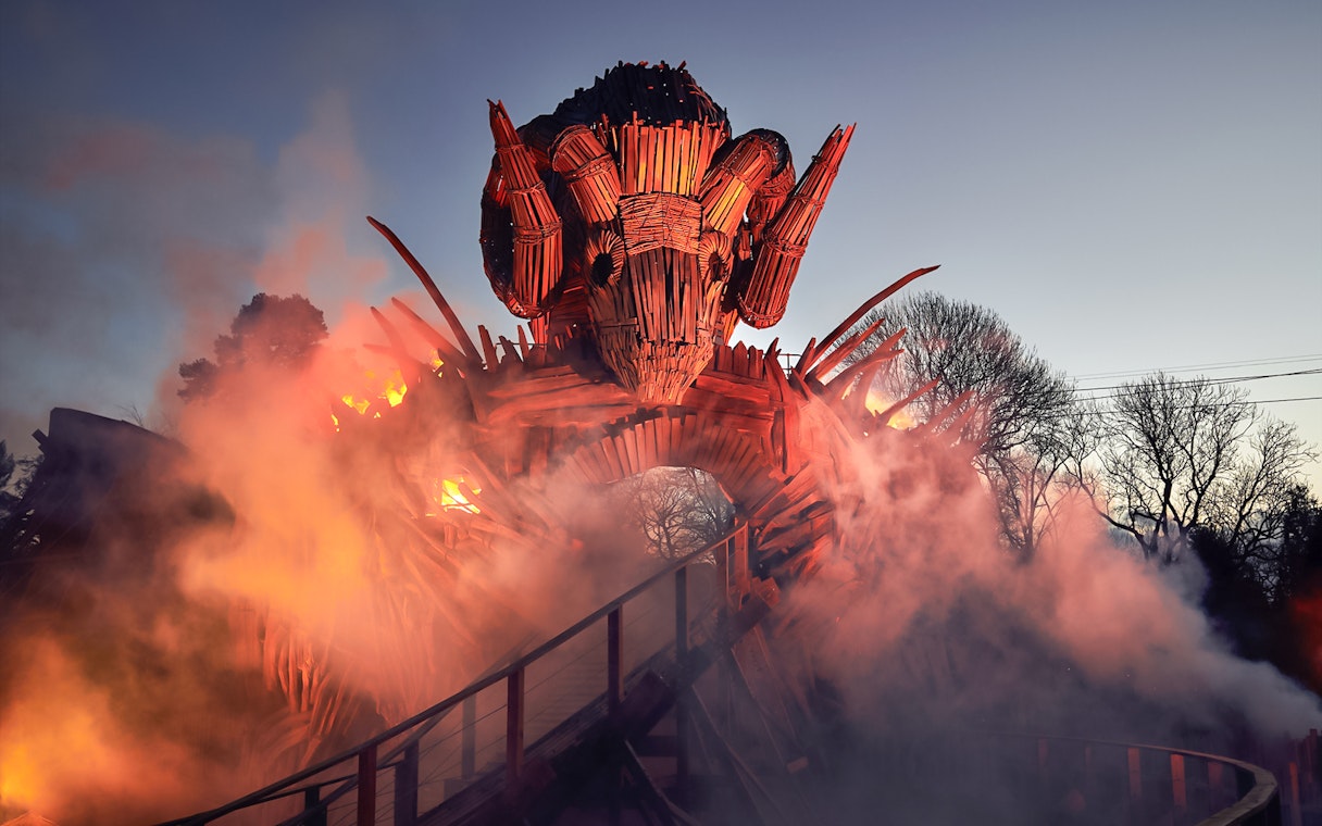 Wicker Man ride structure with flames and smoke at Alton Towers.