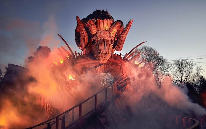 Wicker Man ride structure with flames and smoke at Alton Towers.