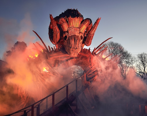 Wicker Man ride structure with flames and smoke at Alton Towers.