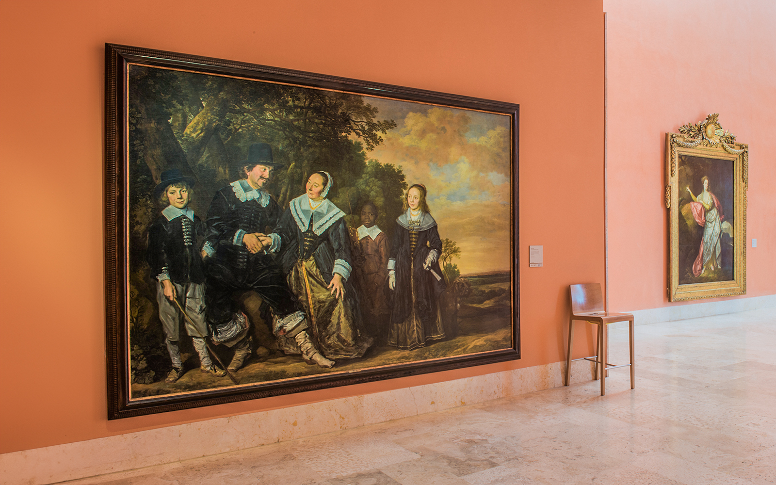 Thyssen Museum exhibit featuring large historical paintings on an orange wall.