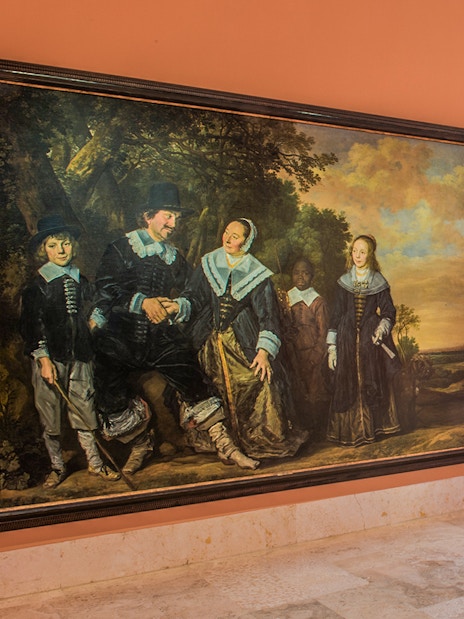 Thyssen Museum exhibit featuring large historical paintings on an orange wall.