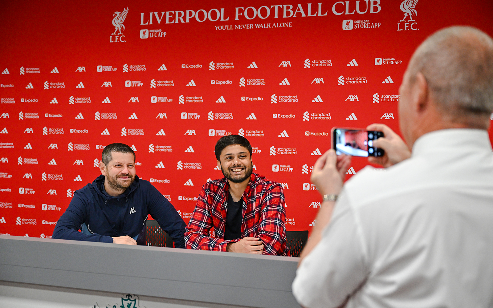 Two people at press room table, Anfield Arena, Liverpool FC.