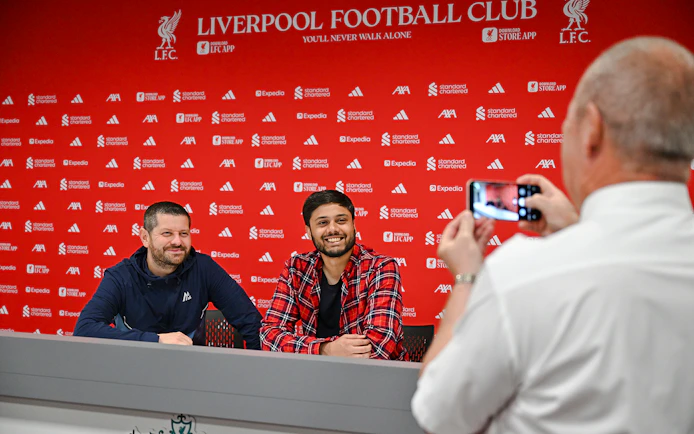 Two people at press room table, Anfield Arena, Liverpool FC.