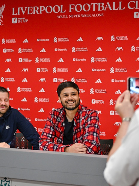 Two people at press room table, Anfield Arena, Liverpool FC.