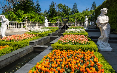Ba Na Hills garden with colorful tulips and classical statues.