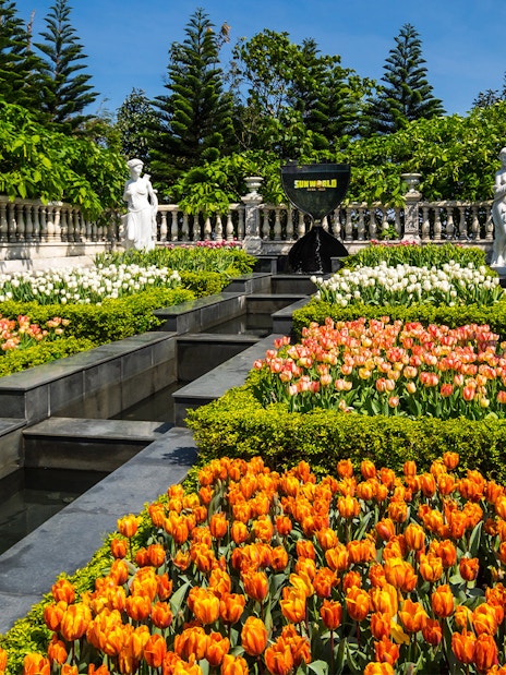 Ba Na Hills garden with colorful tulips and classical statues.