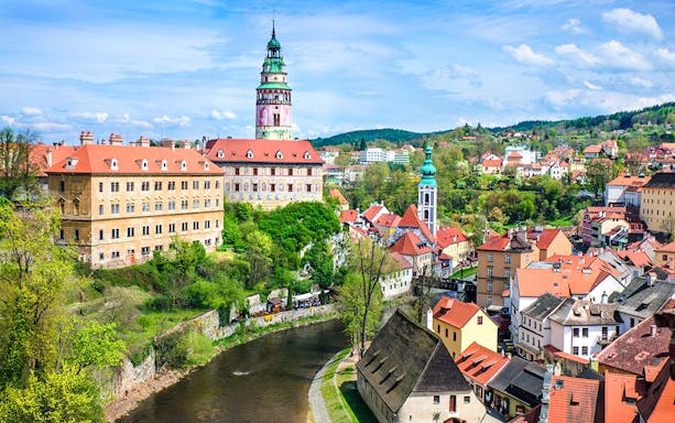 Český Krumlov cityscape with castle tower and Vltava River, Czech Republic.