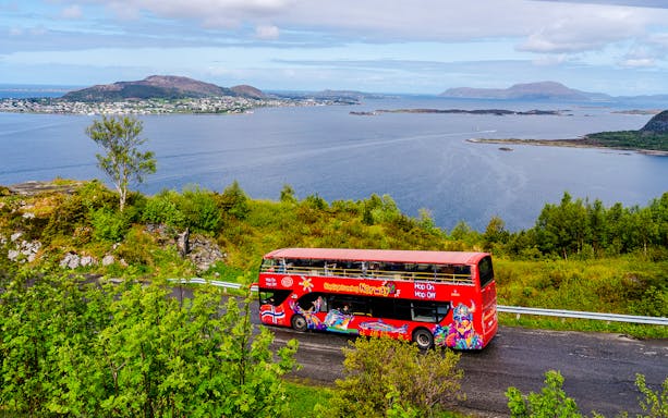 Alesund hop-on hop-off bus with coastal view and islands in Norway.