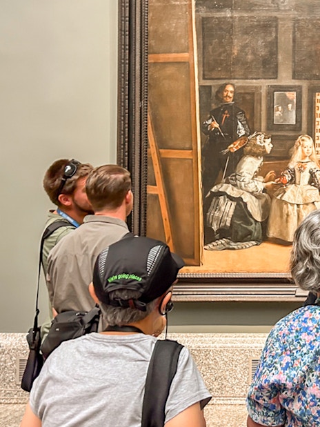 Visitors viewing Velázquez's "Las Meninas" at Prado Museum, Madrid during a guided tour.