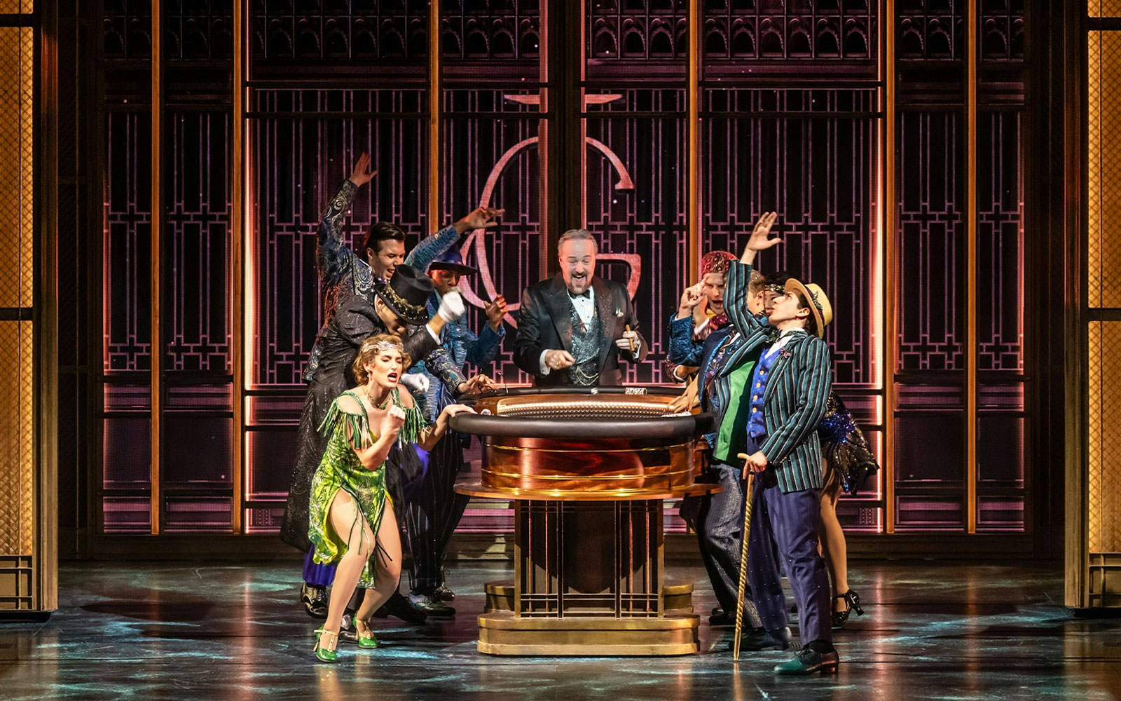Actors performing The Great Gatsby Musical on stage with 1920s costumes and set design.