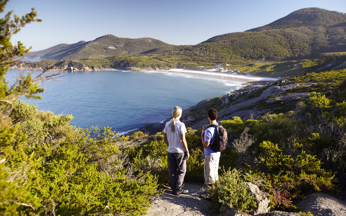 Two people overlooking the coastline at Wilsons Promontory National Park, Australia.
