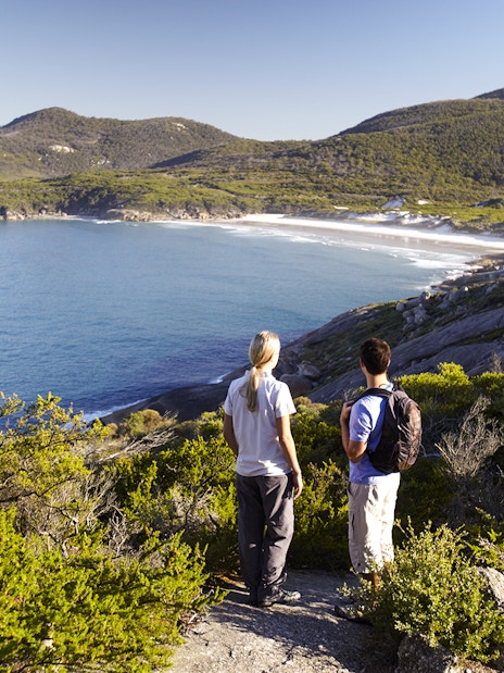 Two people overlooking the coastline at Wilsons Promontory National Park, Australia.