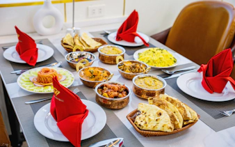 Luxurious Indian meal setup on Ha Long Bay Diamond Era cruise dining table.