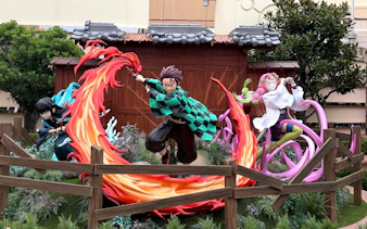 Characters from an anime series in action poses at Universal Studios Japan.