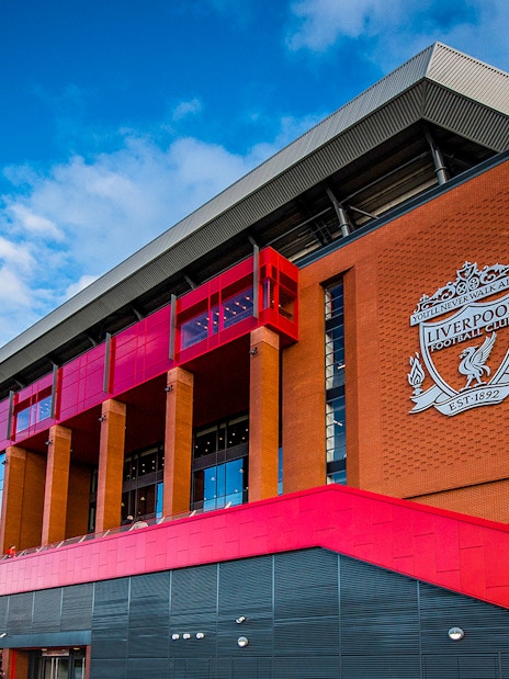 Liverpool FC stadium exterior with club crest, part of Legends Q&A and Stadium Tour.
